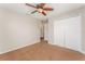 Neutral bedroom featuring a ceiling fan and closet with direct access to a shared bathroom at 5331 River Rock Rd, Lakeland, FL 33809