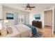 A bright bedroom with a ceiling fan, big windows, and beach themed artwork at 5331 River Rock Rd, Lakeland, FL 33809