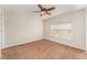 Neutral bedroom with a ceiling fan, tan carpet and one window at 5331 River Rock Rd, Lakeland, FL 33809