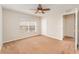 Neutral bedroom with a ceiling fan, tan carpet and one window and closet at 5331 River Rock Rd, Lakeland, FL 33809