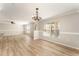 Bright dining area with wood-look floors and a modern chandelier fixture at 5331 River Rock Rd, Lakeland, FL 33809