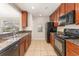 Well-lit kitchen featuring granite countertops, stainless steel sink and black appliances at 5331 River Rock Rd, Lakeland, FL 33809