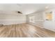 Spacious living room features wood-look floors, a ceiling fan, and natural light at 5331 River Rock Rd, Lakeland, FL 33809