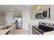 Bright kitchen featuring stainless steel appliances and grey cabinets at 2072 Rosewood Cir, Lakeland, FL 33810