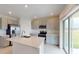 Well-lit kitchen with stainless steel appliances, a central island, and a sliding glass door at 2072 Rosewood Cir, Lakeland, FL 33810