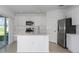 Bright kitchen with stainless steel appliances, an island with sink and white cabinetry at 2072 Rosewood Cir, Lakeland, FL 33810