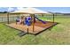 Community playground with slides, climbing structures, and shade covering over a mulch surface at 4216 Singing Mockingbird Blvd, Bartow, FL 33830