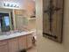 Well-lit bathroom with a framed mirror, single sink vanity, and decorative wall cross at 1565 Hancock St, The Villages, FL 32162