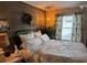 Inviting bedroom featuring a wood accent wall, decorative wreath, and stylish furnishings at 1565 Hancock St, The Villages, FL 32162