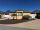 Charming single-story home with a well-maintained lawn, complemented by a young palm tree at 1565 Hancock St, The Villages, FL 32162