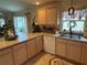 Kitchen with countertop views to the backyard through sliding glass door at 1565 Hancock St, The Villages, FL 32162