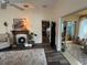 Sun-drenched living area featuring a decorative fireplace, seating, and access to the sunroom at 1565 Hancock St, The Villages, FL 32162