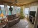 Cozy sunroom bathed in natural light, furnished with comfortable seating and seasonal decorations at 1565 Hancock St, The Villages, FL 32162