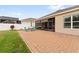 Lush backyard showcasing a brick patio and a screened lanai, perfect for outdoor gatherings at 4763 Riverwalk Dr, St Cloud, FL 34771