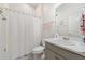 Bathroom with a shower curtain, white tile, and a mirror at 4763 Riverwalk Dr, St Cloud, FL 34771