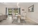 Dining area with view of the backyard, featuring a modern table and stylish chairs at 4763 Riverwalk Dr, St Cloud, FL 34771