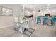 Dining area adjacent to the kitchen featuring a glass table and modern white chairs at 4763 Riverwalk Dr, St Cloud, FL 34771