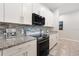 Stylish kitchen featuring granite countertops, stainless steel appliances, and mosaic tile backsplash at 4763 Riverwalk Dr, St Cloud, FL 34771