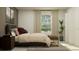 Bedroom featuring a bed, bedside tables, modern accessories, and natural light at 5287 Dagenham Dr, Davenport, FL 33837