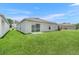 A spacious backyard featuring a lush green lawn at 1931 Rosewood Cir, Lakeland, FL 33810