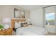 Well-lit bedroom with a plush bed, side tables with lamps, and framed art at 1931 Rosewood Cir, Lakeland, FL 33810