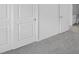 A bedroom with gray carpeting and closet with white doors at 1931 Rosewood Cir, Lakeland, FL 33810