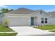 Single story home with a 2 car garage and lush landscaping at 1931 Rosewood Cir, Lakeland, FL 33810