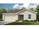 Charming single-story home with a two-car garage and well-manicured lawn at 1931 Rosewood Cir, Lakeland, FL 33810