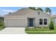 Charming single-story home with a two-car garage, landscaped yard, and covered entry at 1931 Rosewood Cir, Lakeland, FL 33810