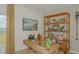 Inviting home office with a wooden desk, shelving unit, and natural light at 1931 Rosewood Cir, Lakeland, FL 33810