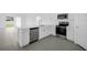 Beautiful kitchen featuring stainless steel appliances, white cabinetry, and gray tile flooring at 1931 Rosewood Cir, Lakeland, FL 33810