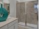 Modern bathroom with a large glass-enclosed shower, sleek vanity, and a calming color palette at 4208 Nightcaps Way, Kissimmee, FL 34746