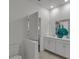 Bright bathroom features white cabinetry, dual sinks, and modern fixtures, plus a decorative vase at 4208 Nightcaps Way, Kissimmee, FL 34746