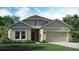 Charming single-Gathering home featuring a manicured lawn, a two-car garage, and inviting front entrance at 4208 Nightcaps Way, Kissimmee, FL 34746