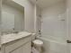 Bathroom featuring a bathtub with shower and a large mirror above the sink at 1040 Cambridge Drive, Winter Haven, FL 33881