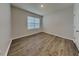 Bright bedroom featuring wood-look flooring and a window for natural light at 1040 Cambridge Drive, Winter Haven, FL 33881