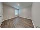 Bedroom featuring wood-look flooring and a window for natural light at 1040 Cambridge Drive, Winter Haven, FL 33881
