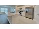 Open-concept kitchen with stainless steel appliances and granite countertops at 1040 Cambridge Drive, Winter Haven, FL 33881
