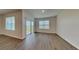 Airy living area with sliding glass doors offering a view, complemented by modern flooring at 1040 Cambridge Drive, Winter Haven, FL 33881