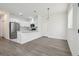 Bright, open-concept living space with wood-look floors and recessed lighting at 2216 W Lanier St, Lakeland, FL 33815
