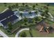 Aerial view of a community pool, playground and green spaces surrounded by trees at 260 Woodsage Pl, Lake Alfred, FL 33850