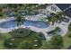 Aerial view of a community pool, playground, splash pad, and lounge areas at 260 Woodsage Pl, Lake Alfred, FL 33850