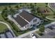 Aerial view of a community clubhouse, pool, playground and parking at 260 Woodsage Pl, Lake Alfred, FL 33850