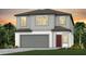 Charming two-story home with a gray color scheme and a two-car garage at 260 Woodsage Pl, Lake Alfred, FL 33850