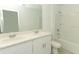 Bathroom with double sink vanity, white cabinets, a large mirror, and a shower-tub combination at 4532 Ranunculus St, Lake Hamilton, FL 33851