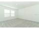 This bedroom features carpeted floors and natural light with two windows at 4532 Ranunculus St, Lake Hamilton, FL 33851
