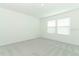 This bedroom features carpeted floors and natural light with two windows at 4532 Ranunculus St, Lake Hamilton, FL 33851