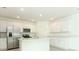 Spacious kitchen with stainless steel appliances, white cabinets, and an island with a sink at 4532 Ranunculus St, Lake Hamilton, FL 33851