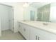 Main bathroom featuring a double sink vanity, a large mirror, and a glass-enclosed shower at 4532 Ranunculus St, Lake Hamilton, FL 33851