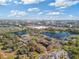 Aerial view of multi-unit dwellings near a lake, retail shopping, and neighborhood at 8825 Latrec Ave # 6308, Orlando, FL 32819